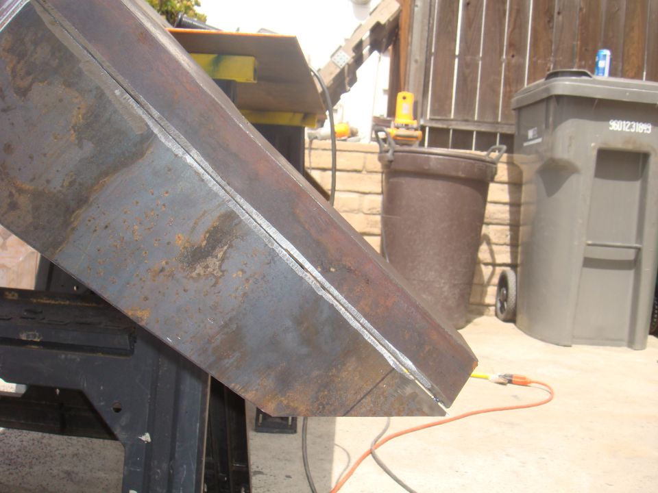 Metal fabrication part with visible weld lines and rust