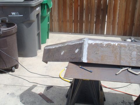 1992 Ford Bronco - Custom metal bumper fabrication in progress, with welding supplies and trash cans nearby.