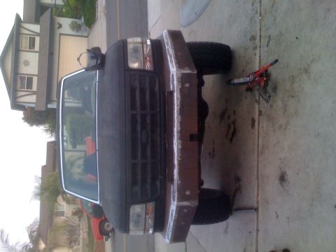 1992 Ford Bronco - Front view of a black 1992 Ford Bronco with a custom bumper, parked in a driveway.