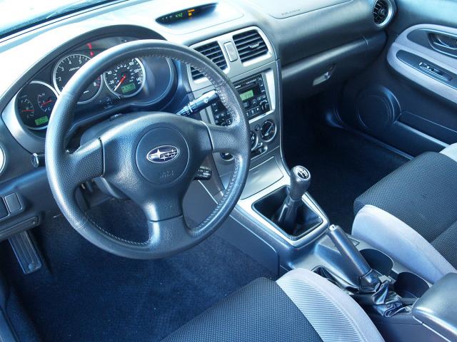 Interior of a 2007 Subaru Impreza showing the steering wheel, dashboard, and gear shift