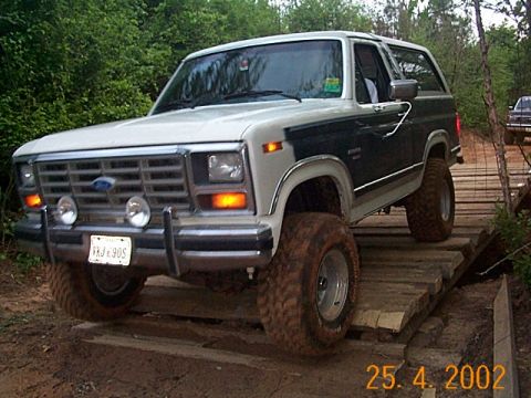 1986 Ford Bronco - This Ford Bronco is navigating an off-road obstacle course on a wooden bridge.