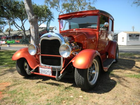 1997 Ford Ranger - This vintage hot rod truck, likely from the late 1920s, is parked on a grassy area under a tree.