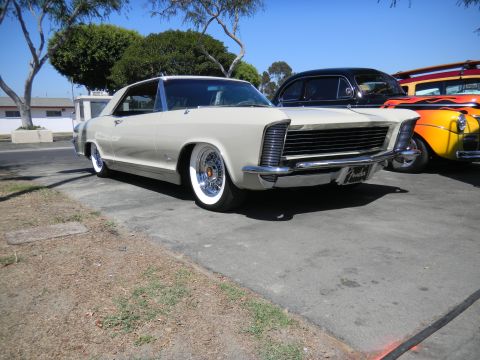 1997 Ford Ranger - A classic Buick Riviera is parked alongside other vehicles under a sunny sky.