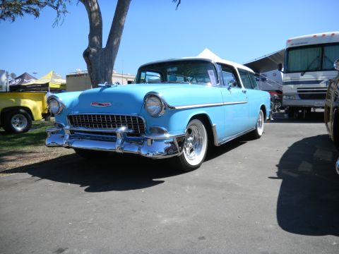 1997 Ford Ranger - A light blue 1955 Chevrolet station wagon is parked at an outdoor event, with a yellow truck and RV visible in the background.
