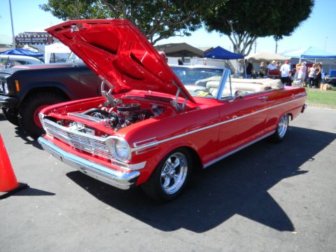 1997 Ford Ranger - A red 1966 Chevrolet Nova convertible is displayed with its hood open at an outdoor event.