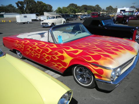 1997 Ford Ranger - A classic red convertible with flame graphics is displayed at a car show.