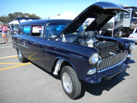1997 Ford Ranger - A dark blue 1955 Chevrolet station wagon is displayed with its hood open at a car show.