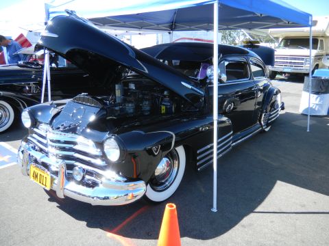 1997 Ford Ranger - Customized classic car on display under a canopy, with other vehicles nearby.