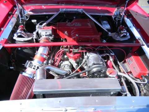 1997 Ford Ranger - Customized engine bay a red E4OD transmission and V8 engine, with polished chrome components and a red air intake.