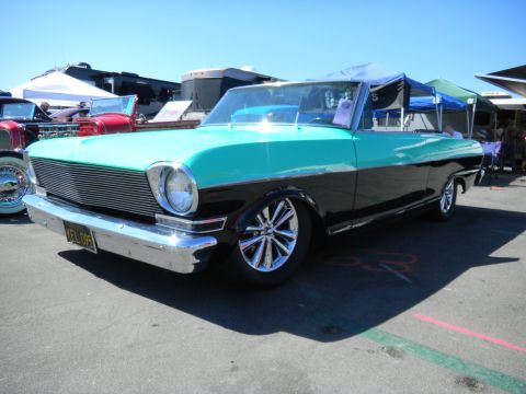 1997 Ford Ranger - A two-tone 1963 Chevrolet Nova convertible with chrome wheels is parked at an outdoor event.