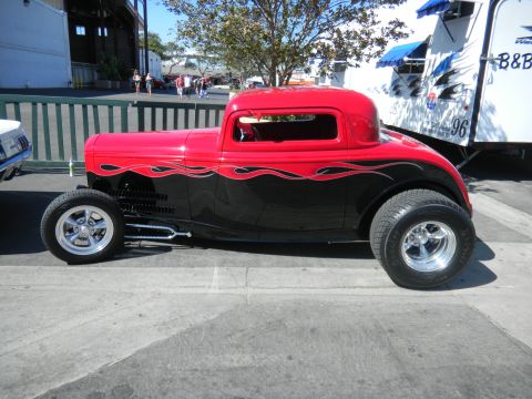 1997 Ford Ranger - A custom hot rod coupe with a two-tone paint job and flame graphics is parked outdoors.