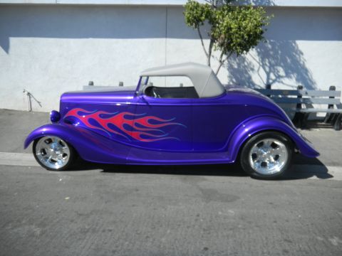 1997 Ford Ranger - Custom purple hot rod with flame graphics parked outdoors.