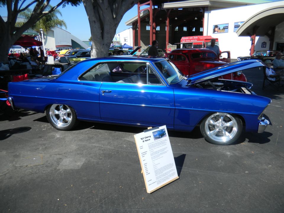 Blue 1967 Chevrolet Nova SS coupe, hood open, with display board
