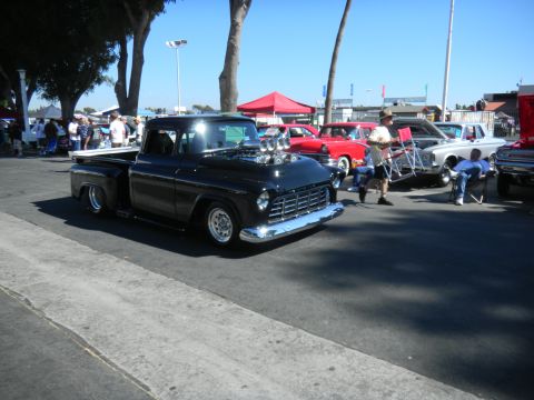 1997 Ford Ranger - A heavily modified 1950s Chevrolet pickup truck with a prominent supercharger is displayed at an outdoor car show.