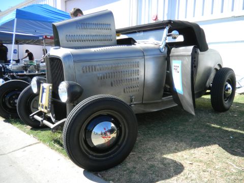 1997 Ford Ranger - A custom hot rod with a bare metal finish and exposed engine components is displayed outdoors.