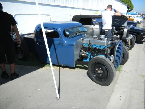 1997 Ford Ranger - A blue hot rod truck is displayed at an outdoor event with other vehicles visible.