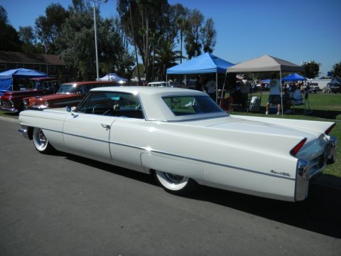 1997 Ford Ranger - A classic white Cadillac convertible with distinctive tail fins is parked at an outdoor event.