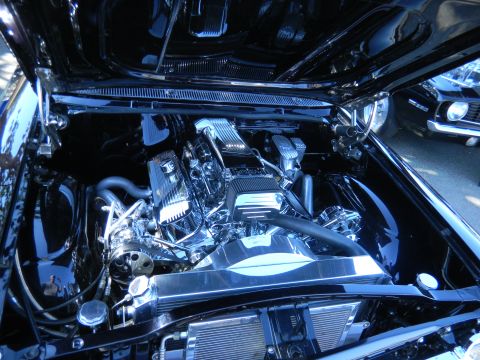 1997 Ford Ranger - Customized engine bay with polished chrome components and a powerful V8 engine, seen at a car show.