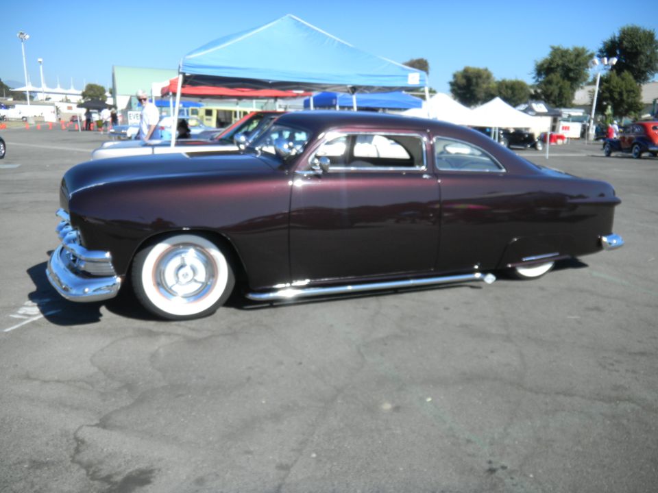 Dark metallic purple custom coupe with whitewall tires and side pipes