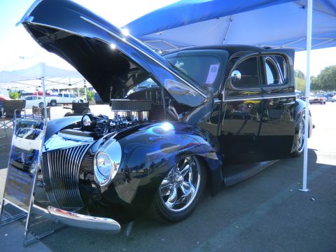 1997 Ford Ranger - A custom hot rod with its hood open, displaying a chrome grille and blue flame paintwork.