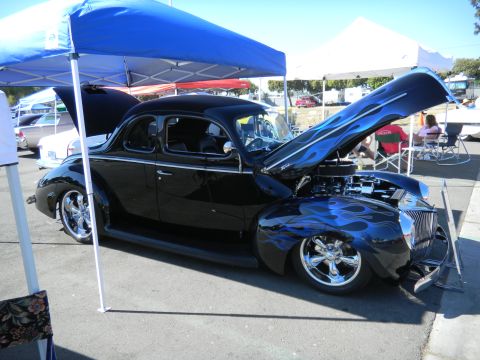 1997 Ford Ranger - Custom black coupe with blue flame graphics and chrome wheels displayed at a car show.