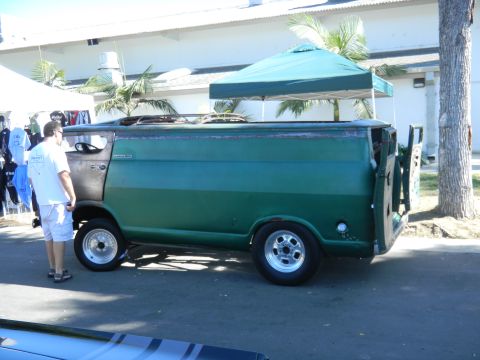 1997 Ford Ranger - A man stands next to a green van at an outdoor event.