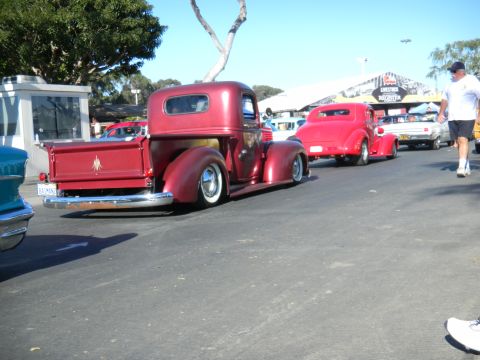1997 Ford Ranger - Two classic red vehicles, a pickup and a coupe, are parked together on a sunny day.