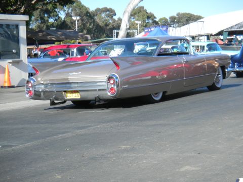 1997 Ford Ranger - Rear view of a tan 1959 Cadillac Coupe de Ville at an outdoor event.