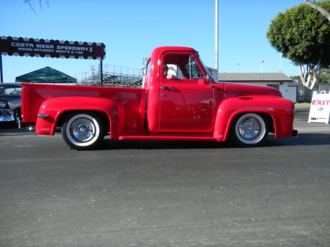 1997 Ford Ranger - A bright red 1953 Ford F-100 pickup truck is parked at the Costa Mesa Speedway, a lowered stance and whitewall tires.