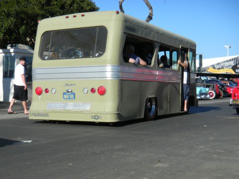 1997 Ford Ranger - A retro bus with a custom paint job and lowered suspension is parked outdoors with other vehicles.