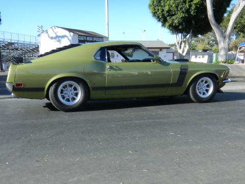 1997 Ford Ranger - Side view of a green 1969 Ford Mustang Boss 302 with black stripe detail.