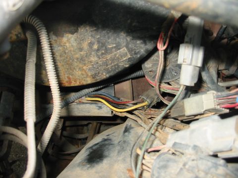 1988 Ford Bronco - Close-up of a vehicle's wiring harness, showing multiple connectors and wires.
