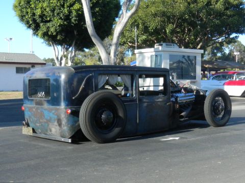 1997 Ford Ranger - This heavily modified sedan features an exposed engine and an external spare tire, with a distinctive patina finish.