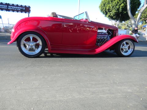 1997 Ford Ranger - Side view of a red 1932 Ford hot rod convertible parked on asphalt.