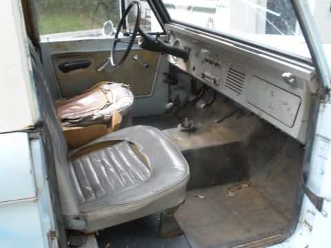 1966 Ford Bronco - Interior view of a 1966 Ford Bronco, a worn driver's seat and dashboard.