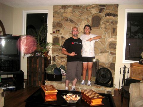1996 Ford Bronco - A man and woman pose for a photo in front of a rustic stone fireplace in a living room.