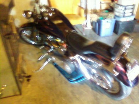 2000 Harley-Davidson FXDWGI Wide Glide - A black Harley-Davidson motorcycle with chrome details is parked indoors.