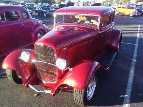 2000 Harley-Davidson FXDWGI Wide Glide - A red hot rod coupe is parked in a lot with other vehicles visible.