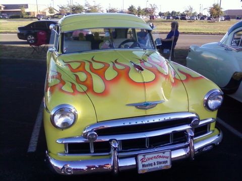 2000 Harley-Davidson FXDWGI Wide Glide - A yellow Chevrolet with flame decals is parked next to another vintage car.