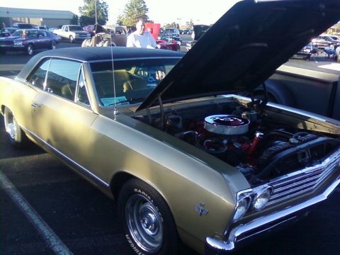 2000 Harley-Davidson FXDWGI Wide Glide - A gold 1967 Chevrolet Chevelle SS is displayed with its hood open at a car show.