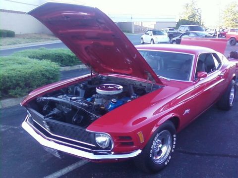 2000 Harley-Davidson FXDWGI Wide Glide - A red 1970s Ford Mustang is parked with its hood open, revealing the engine bay.
