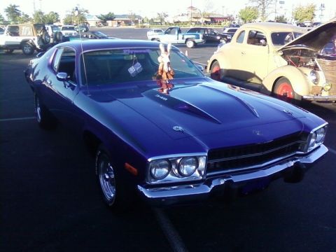 2000 Harley-Davidson FXDWGI Wide Glide - A purple Plymouth muscle car is parked at an outdoor event with other vehicles visible.