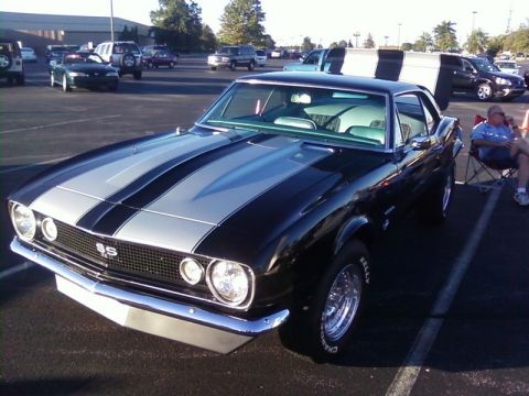 2000 Harley-Davidson FXDWGI Wide Glide - A classic black 1967 Chevrolet Camaro SS with silver racing stripes is parked in a lot.