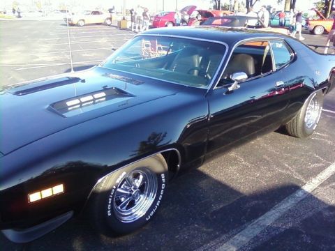 2000 Harley-Davidson FXDWGI Wide Glide - A black muscle car with distinctive hood scoops and chrome wheels is parked outdoors.