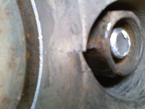 1990 Ford Bronco - This image shows a close-up of a rusty metal part with a bolt.