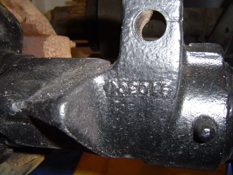1995 Ford Bronco - Close-up of a black metal automotive part showing stamped identification numbers.