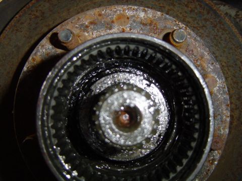 1995 Ford Bronco - Close-up view of a rusted hub assembly with visible splines and grease.