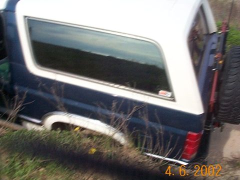 1986 Ford Bronco - This 1986 Ford Bronco is seen from the rear, a blue and white paint scheme and a spare tire mounted externally.
