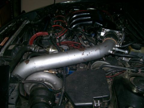 1995 Ford Probe - Close-up view of a modified engine bay a turbocharger and intake system.