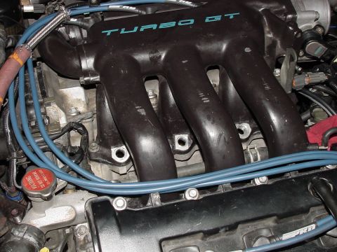 1995 Ford Probe - Close-up of a black engine intake manifold "TURBO GT" text.